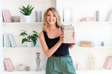 Female student holding books. Beautiful blonde girl keeps a stack of books and smiling. The concept...