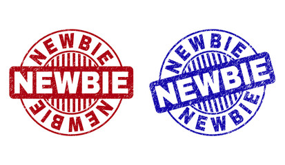 Grunge NEWBIE round stamp seals isolated on a white background. Round seals with distress texture in red and blue colors. Vector rubber watermark of NEWBIE label inside circle form with stripes.