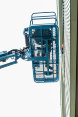 High-rise building maintenance engineers using cranes