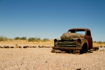 Abandoned car on a road in Namibia