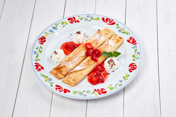 crepes with strawberry sauce and whipped cream