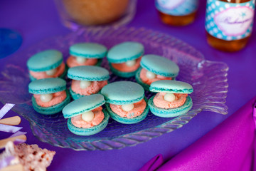 Candy bar, contains fruits, cup cakes, chocolate and another sweet desserts on the wedding. Banquet service. Catering buffet style. Macaroons.Macaron.