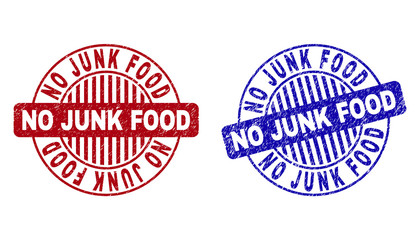 Grunge NO JUNK FOOD round stamp seals isolated on a white background. Round seals with grunge texture in red and blue colors.