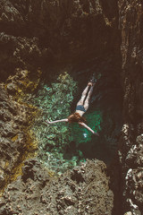 Young girl  swim in the natural pool