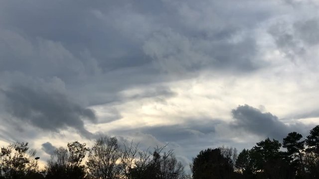 DJI Osmo Mobile 2 time lapse clouds about tree line in the afternoon