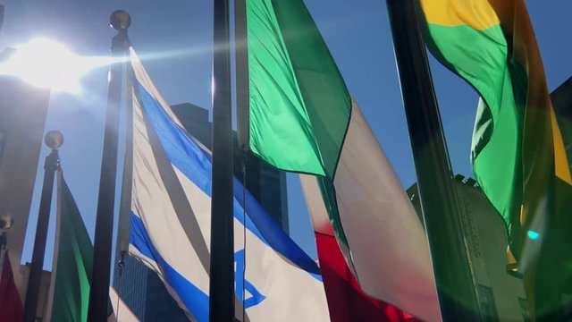 International flags from around the world.
Close up of Italian and Israel flags gently blowing.
Shot into sunlight.
