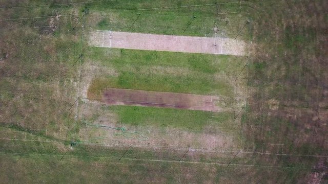 Aerial drone shot of dry cricket pitch in the summer