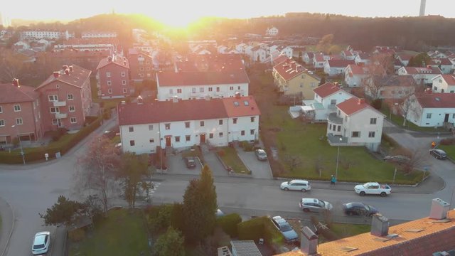 Aerial video of a nice suburban area at sunrise or sunset with people out exercising in Orgryte, Gothenburg, Sweden