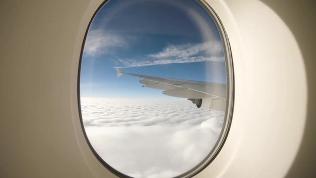 Passenger view from the airplane window high above the clouds