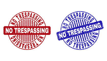 Grunge NO TRESPASSING round stamp seals isolated on a white background. Round seals with grunge texture in red and blue colors.