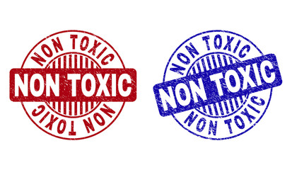 Grunge NON TOXIC round stamp seals isolated on a white background. Round seals with grunge texture in red and blue colors. Vector rubber overlay of NON TOXIC title inside circle form with stripes.