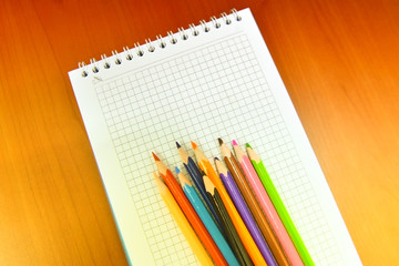 pencils and notebook on white background