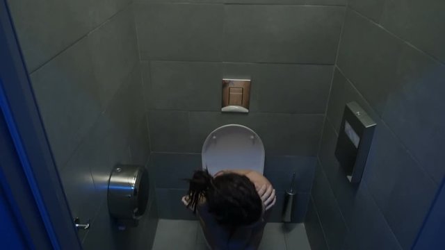 girl sitting on the toilet