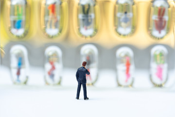 Miniature people, recruiters finding the candidates on the wall. Human resource concept, recruiting, hiring process.