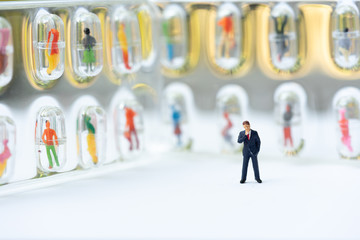 Miniature people, recruiters finding the candidates on the wall. Human resource concept, recruiting, hiring process.