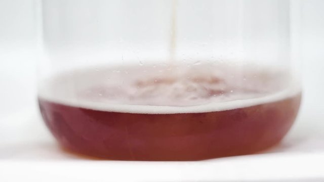 Slow Motion shot of serving beer on a glass