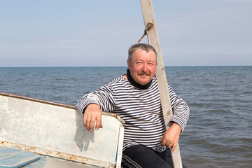 The captain sits on a boat