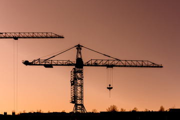 crane silhouette at sunset, urban view