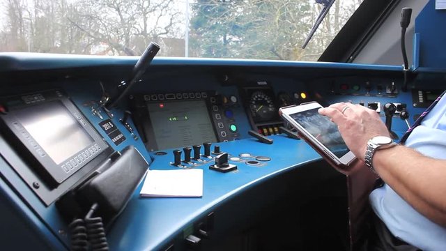 Danish conductor preparing for the ride and clicking on the tablet.