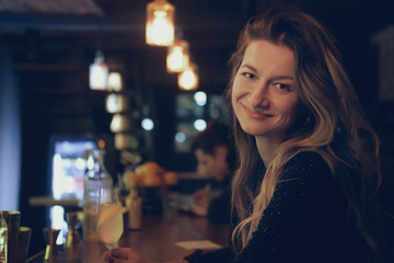 Pretty girl in bar spending time and having cocktail