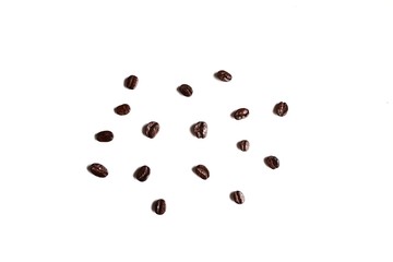 In selective focus many dark roasted coffee beans on white isolated background 