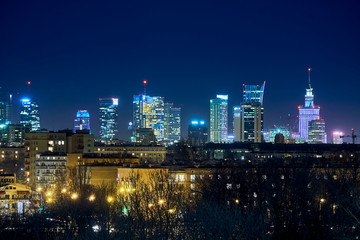 Beautiful, amazing panoramic view of Warsaw (Poland) with skyscrapers and a Palace of Culture and Science during spring flowering at night