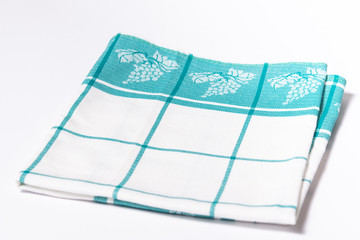 Kitchen cotton white and green towel on the white background. Copy space with kitchen tablecloth on the white background.