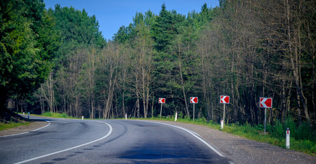 Summer asphalt road. Russian road. Road turn.