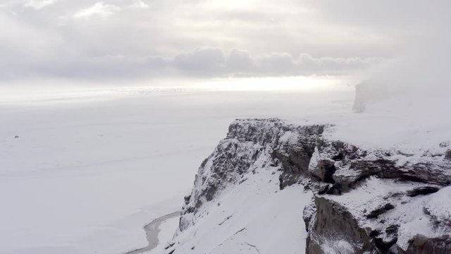 Snowy Mountain in the Morning Covered in Cloud and Birds