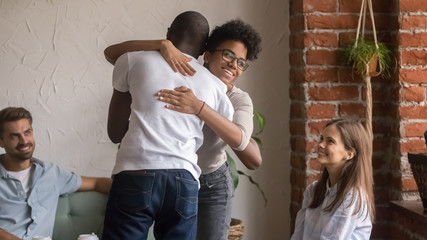 Happy african man and woman hugging greeting at friends meeting © fizkes