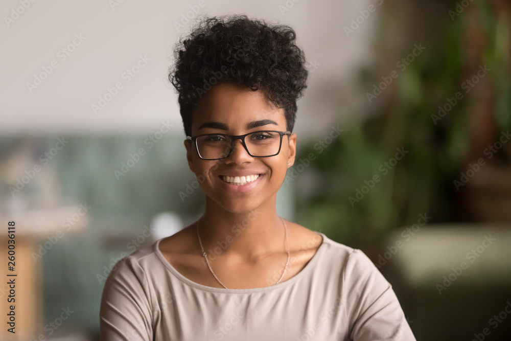 Wall mural Headshot portrait of happy mixed race african girl wearing glasses