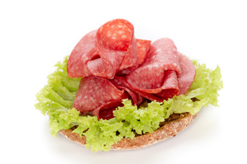 Sandwich with salami sausage on white background.