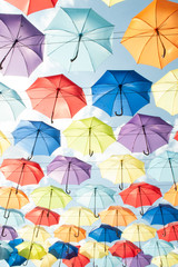 Fototapeta na wymiar Multi-colored umbrellas against the sky