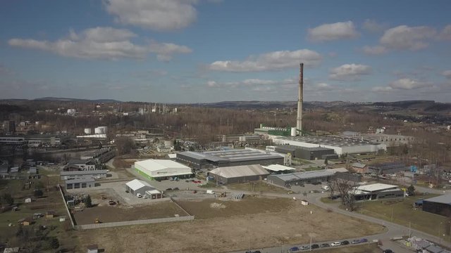 Gorlice, Poland - 3 9 2019: Industrial region of the Carpathian city. Top view of the refinery and auxiliary buildings. Video shot by drone or quadrocopter. Vanity of the day at the factory. Planning 