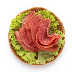 Sandwich with salami sausage on white background.