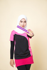 Sport Girl Wearing a Black/Pink Shirt and White Shawl is Running with a Baton