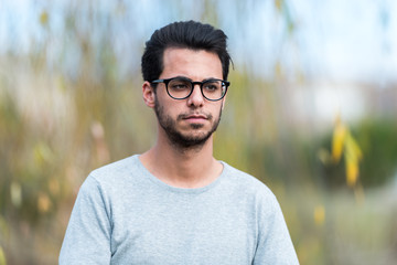 Young student of computer science poses at the campus park near the Polytechnic School