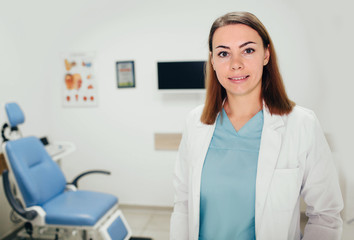 Portrait of smiling young female doctor standing at hospital.