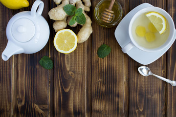 Ginger tea and ingredients on the brown  background.Top view.Copy space.