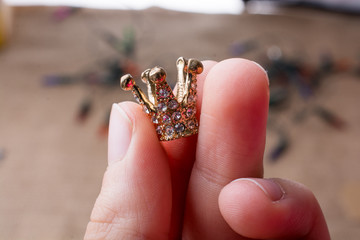Little gold color crown in hand with
