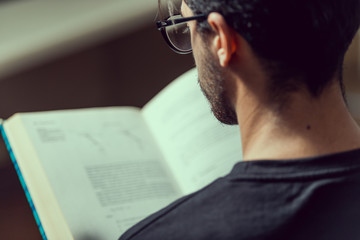Young computer science student reads an advanced robotics book in Caceres, Spain.