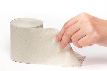Hand pulls toilet paper on a white background