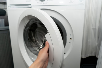 Female open the door in an automatic washing machine