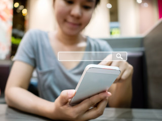 Women use smartphones to find what they are interested in. Searching information data on internet...
