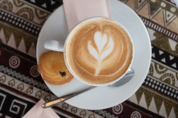 Coffee cup with latte art foam on wood table in coffee shop with copy space.Coffee is one of the most popular beverages.Improve Energy Levels and Burn Fat