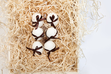 easter chocolate eggs box brown drawer wooden white straw splints yellow dutch bow ribbon holland