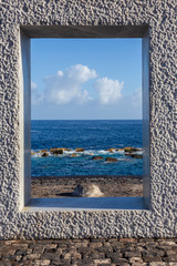 View of the Ocean through a window sculpture in  Garachico Tenerife. Canary Islands. Spain.