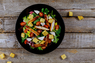 Fresh salad with chicken breast, arugula and tomato. Top view