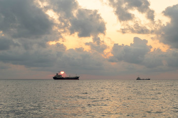 cargo ship on the ocean with sunrise