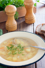 Transparent potato soup in meat broth, selective focus